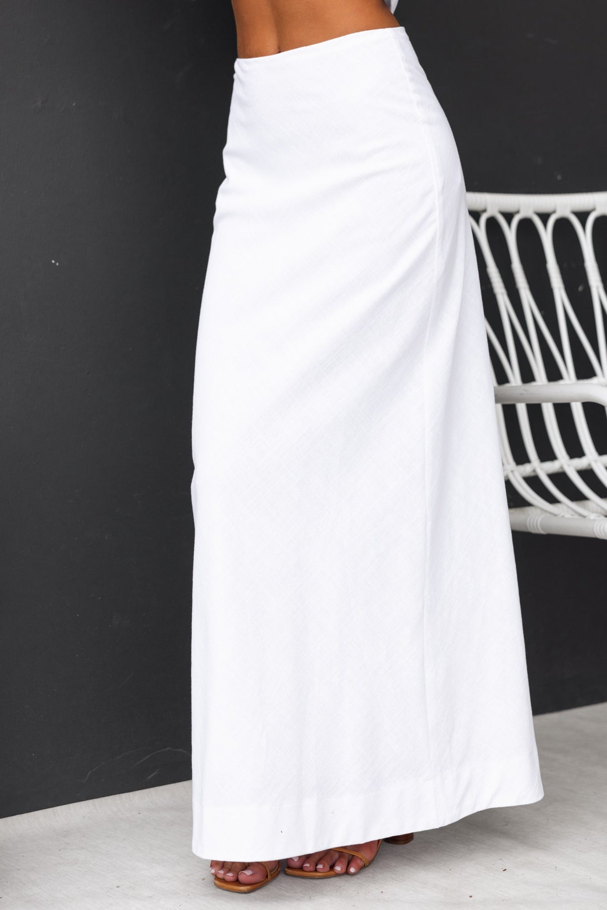 White Bexley Maxi Skirt with mid-high waist fit and invisible zip, styled on model against a dark background.