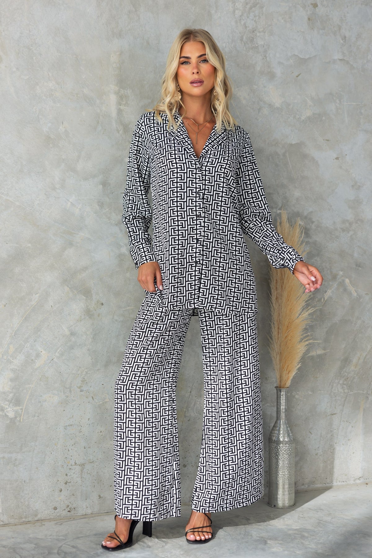 Model wearing the Steffy Shirt with abstract print, featuring a button-up front and wide-leg pants.