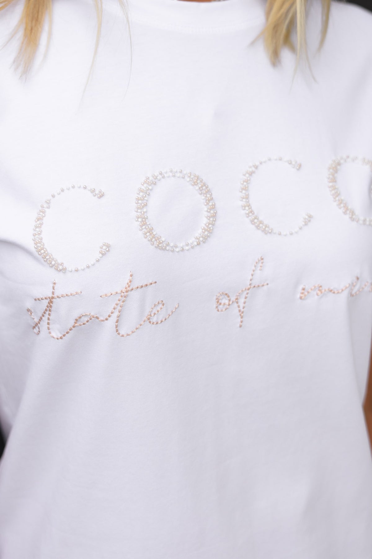 White Margot Tee featuring 'Coco state of mind' with bead detail and round neckline, crafted from soft stretch cotton.