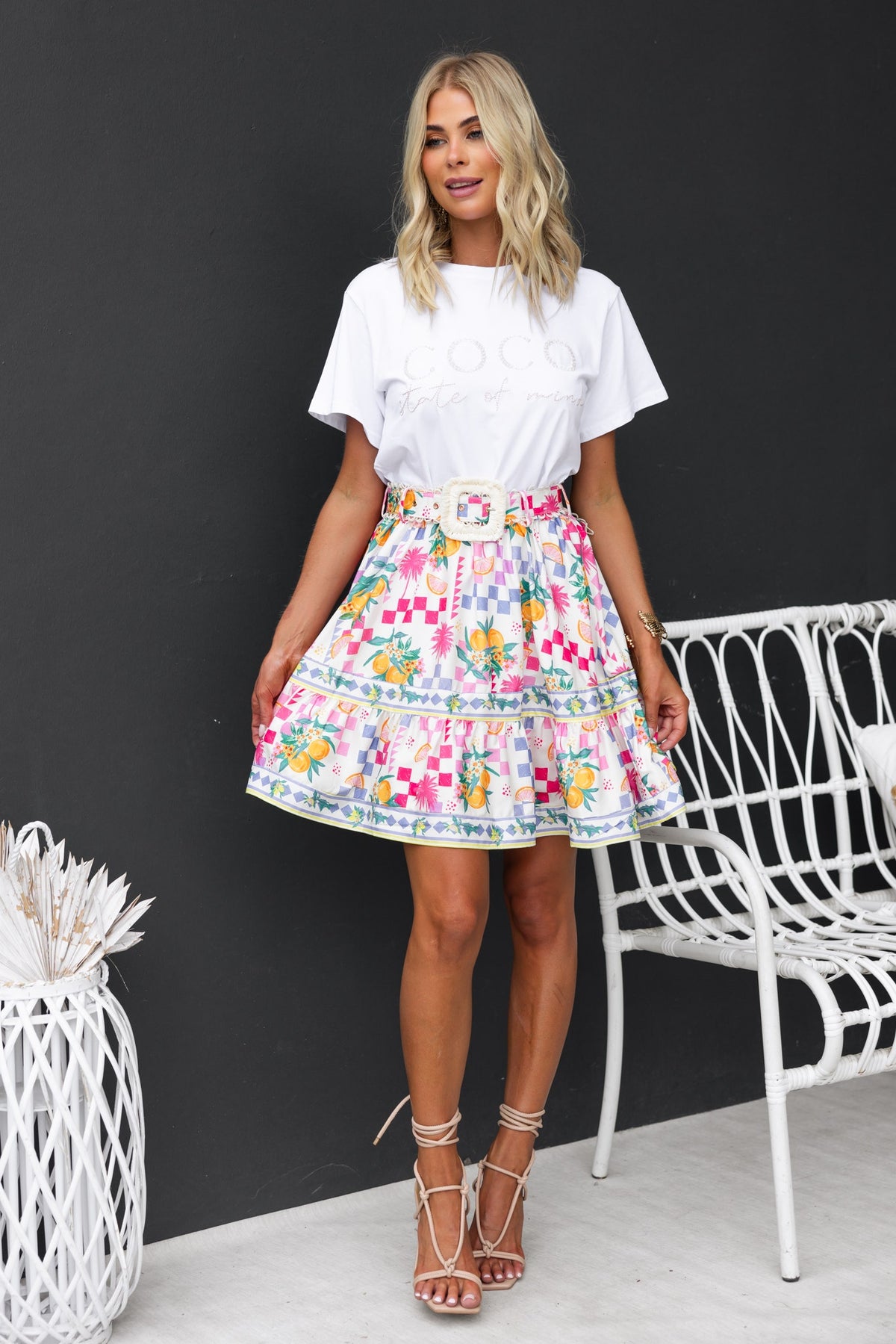 Talisa Skirt featuring vibrant abstract print, mid-high waist, removable belt, and lightweight fabric for a stylish summer look.