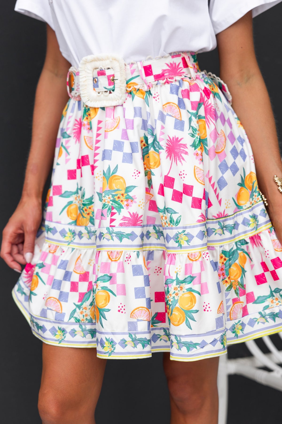 Talisa skirt featuring an abstract print, mid-high waist, removable belt, and elastic waistband, perfect for summer wear.