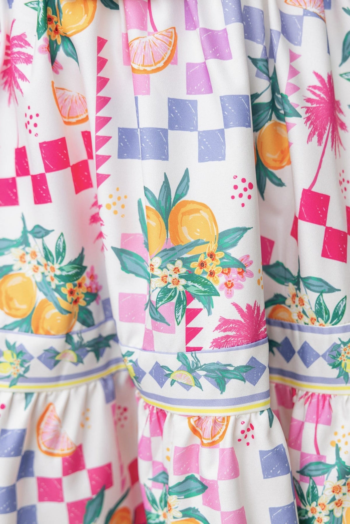 Colorful abstract print on Talisa Skirt featuring lemons and floral patterns, mid-high waist design with elastic waistband.