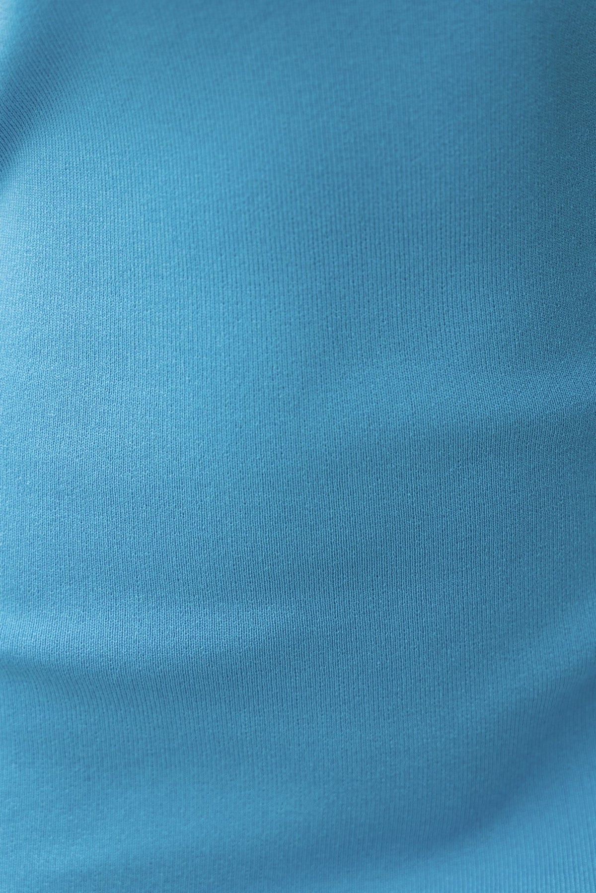 Close-up of a smooth, ribbed blue fabric texture, showcasing stretch and vibrant color.