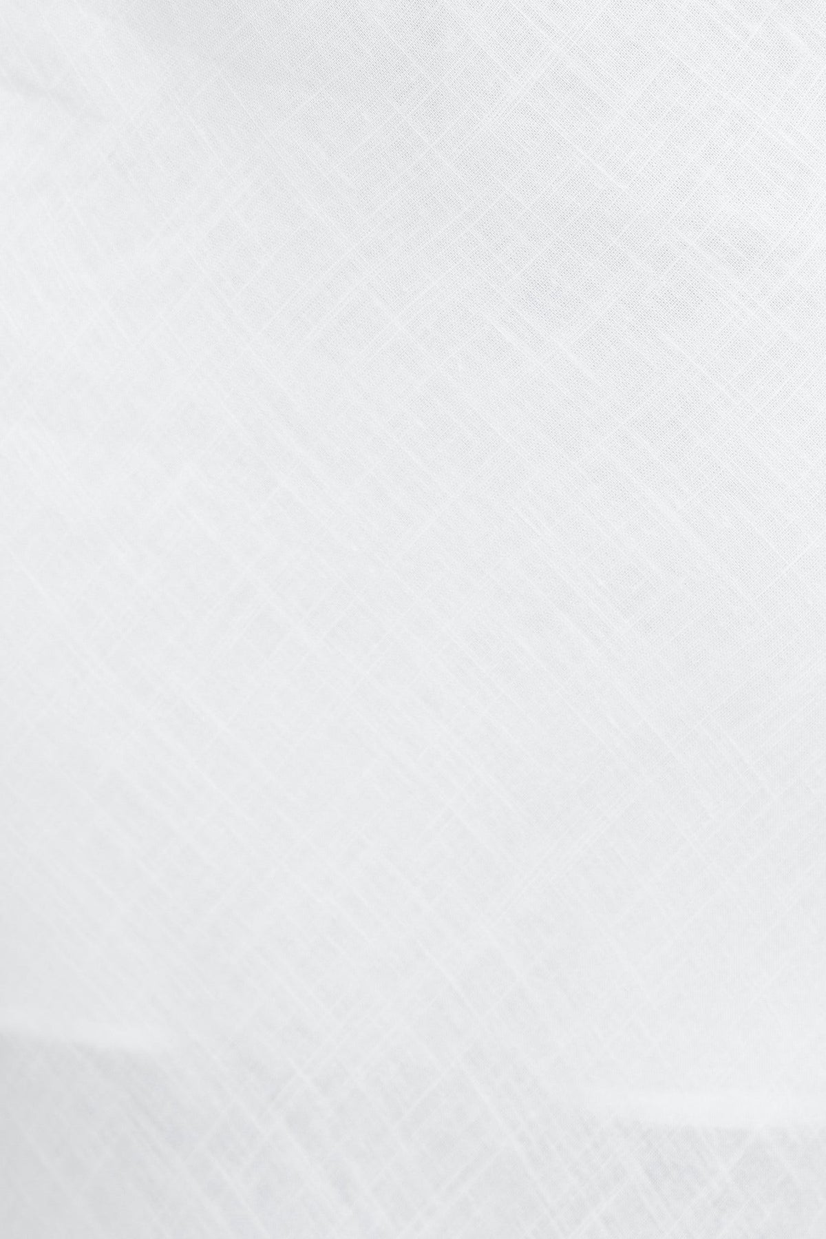 Close-up of textured linen fabric in soft white, showcasing a light and breathable material for clothing.