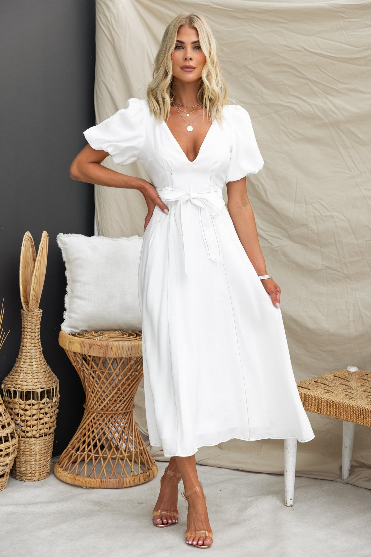 Orderly midi dress with V-neckline, elastic sleeves, and removable tie, styled in white, perfect for summer occasions.