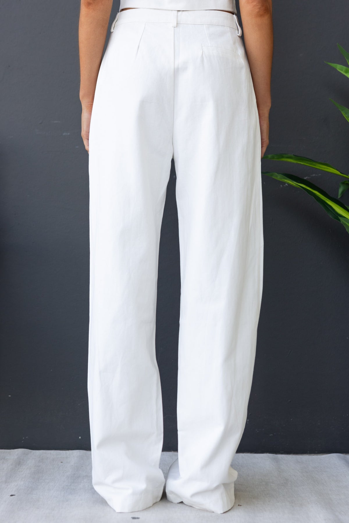 Back view of Rayden Denim Pants featuring a mid-high waist fit and wide legs in white cotton.