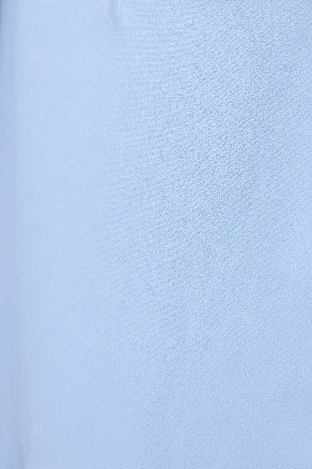 Close-up of textural fabric of Lupton Blazer in light blue, showcasing smooth surface and vibrant color.