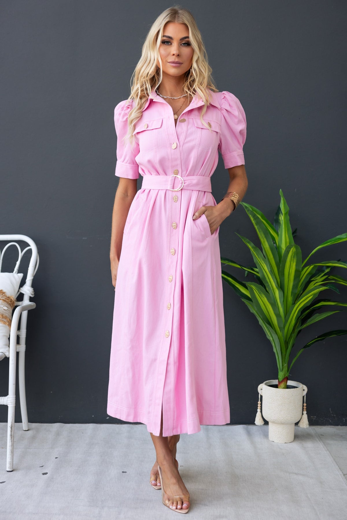 Stylish pink denim maxi dress with button-up front, removable belt, and pockets, perfect for casual outings.