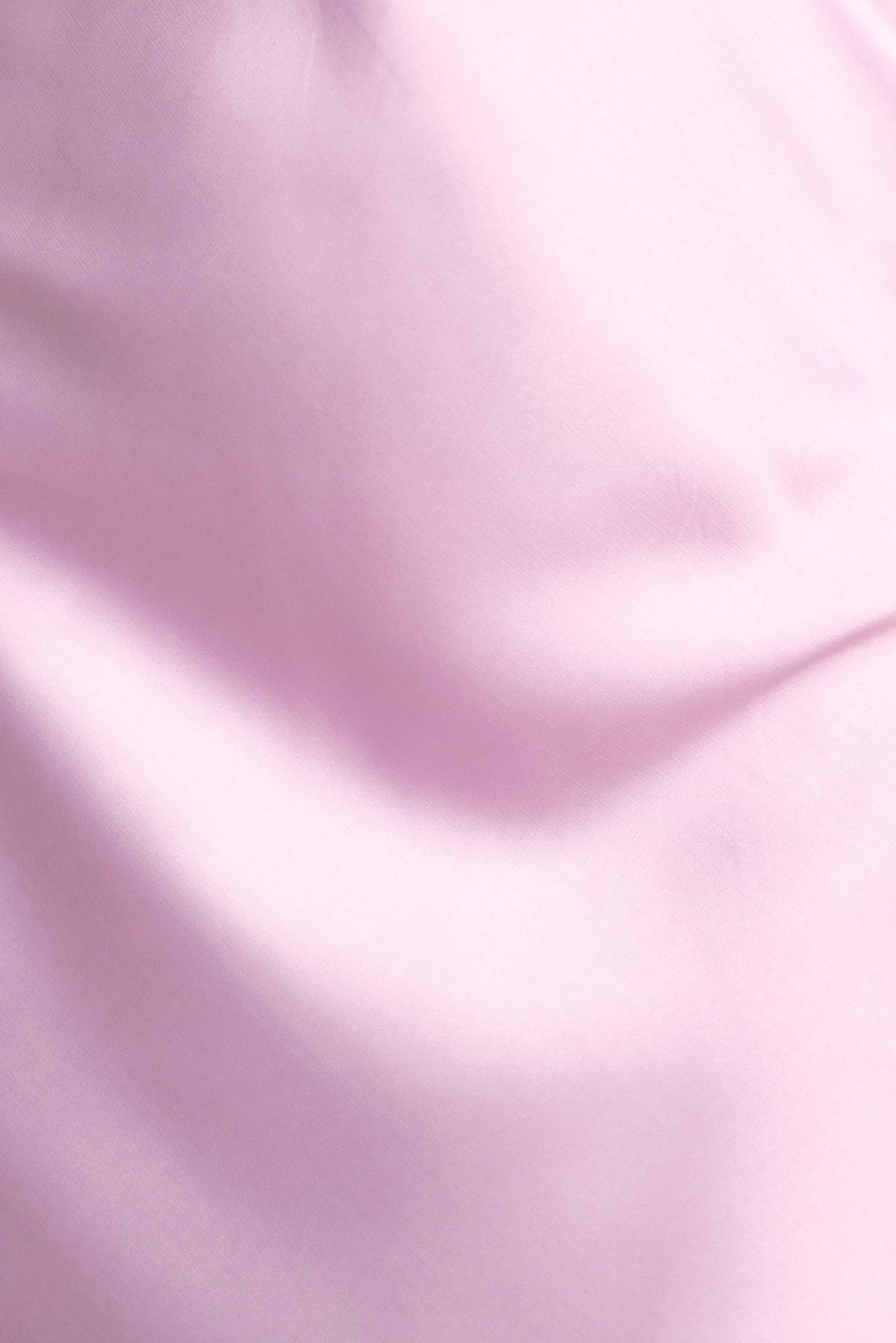 Close-up of soft pink satin fabric, showcasing smooth texture and luxurious finish, ideal for apparel like dresses.