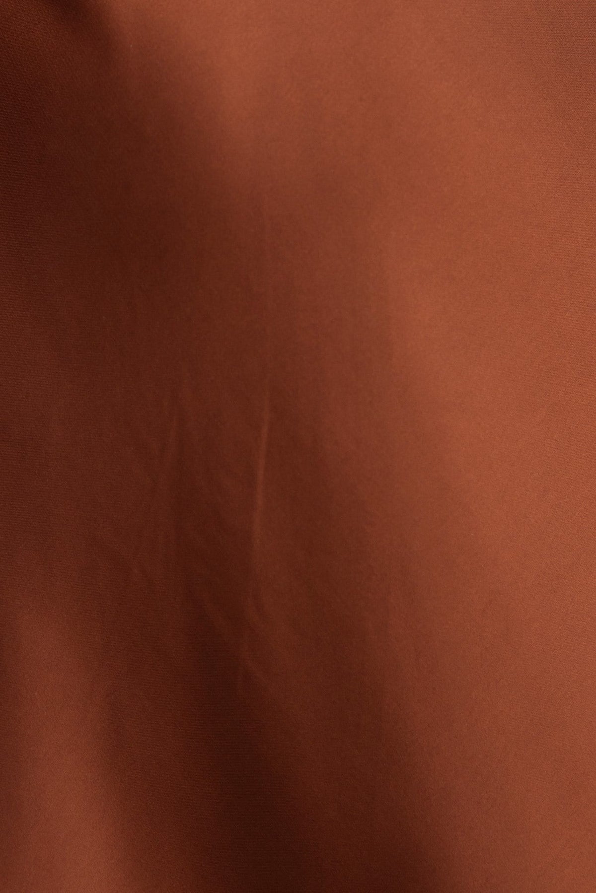 Close-up of rich brown satin fabric texture, showcasing a smooth and elegant surface.
