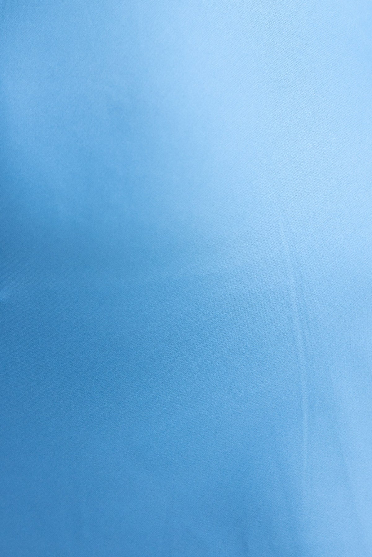 Close-up of smooth light blue satin fabric, perfect for elegant dress designs like the Aerida Midi Dress.