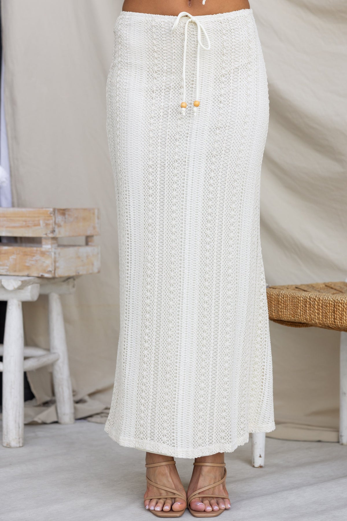 Odae Maxi Skirt in crochet material with tie detail, mid-high waist fit, perfect for summer styling.