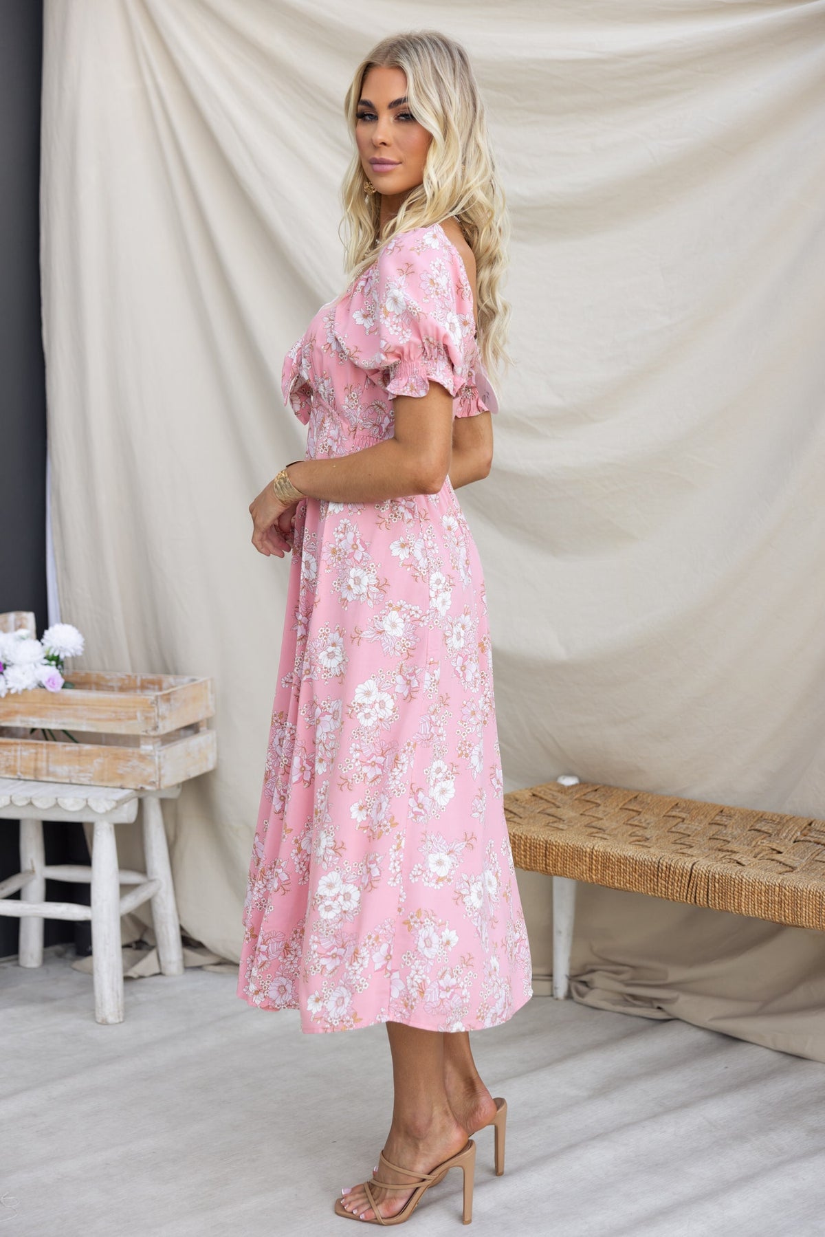 Side view of Rayanna Midi Dress in pink floral print, featuring elastic sleeves and a button-up bust.