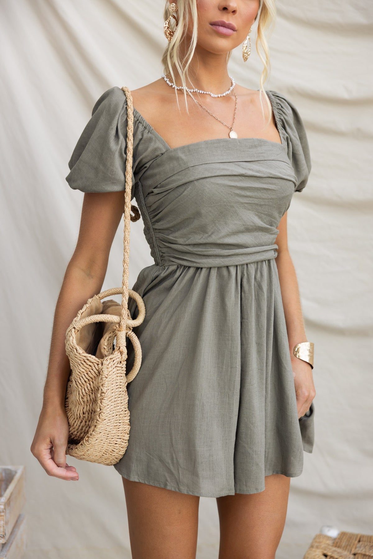 Kippy Playsuit in olive green with square neckline, puff sleeves, and bohemian accessories.