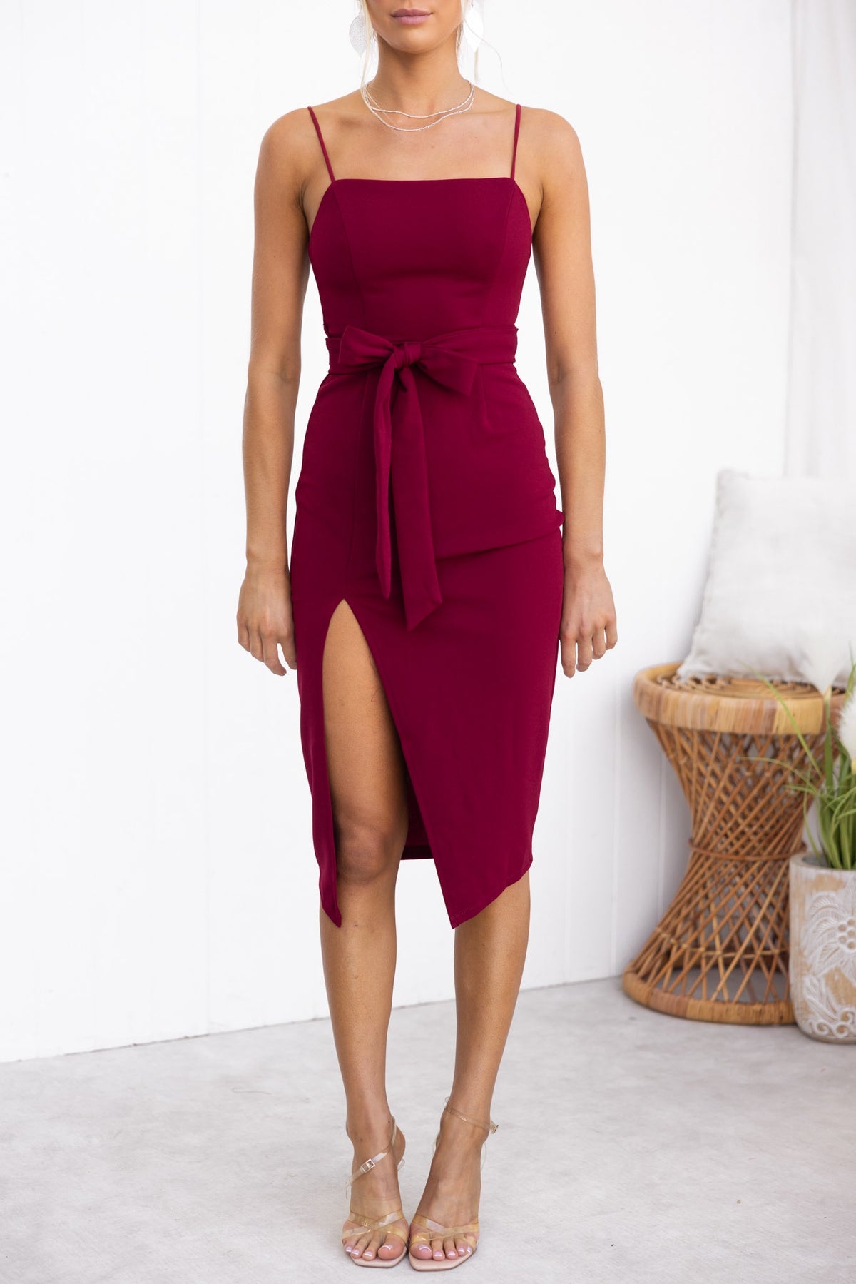 Rios Midi Dress in burgundy with square neckline, tie waist, and front split, styled on model.
