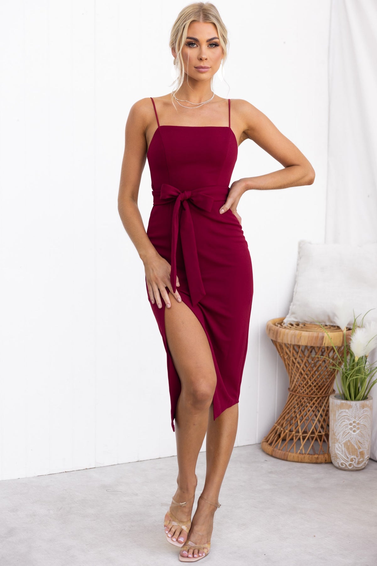 Rios Midi Dress in burgundy with square neckline, tie detail, and front split, perfect for stylish occasions.