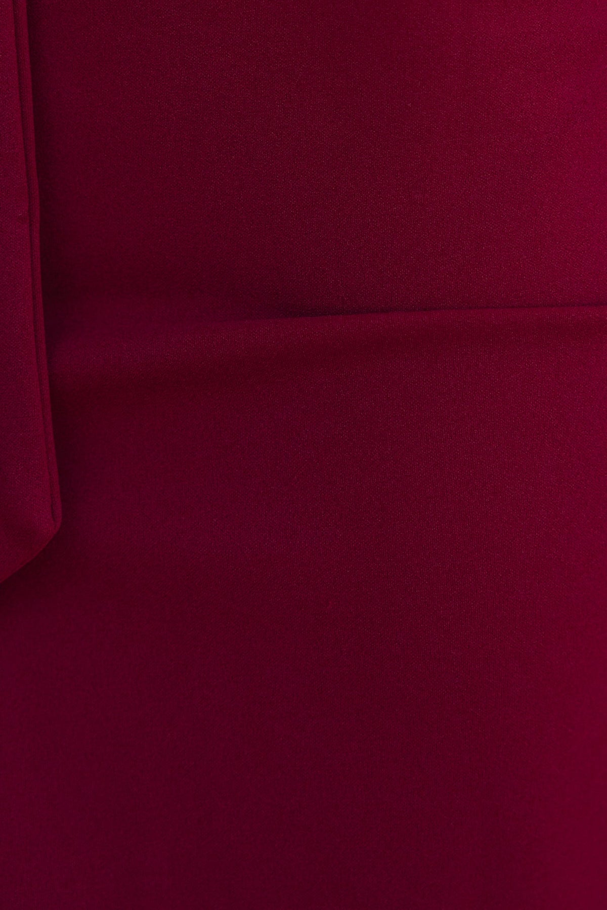 Close-up of deep burgundy fabric, showcasing the smooth texture of the stretchy material used in the Rios Midi Dress.