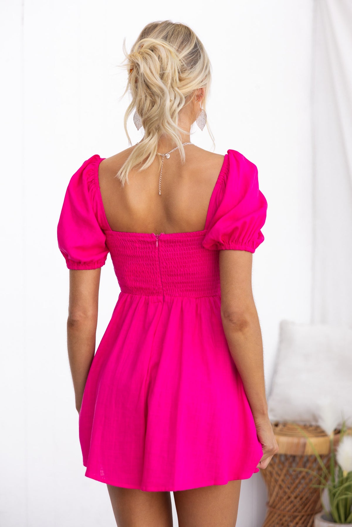 Back view of a pink Kippy Playsuit featuring a square neckline and puff sleeves, ideal for summer outings.