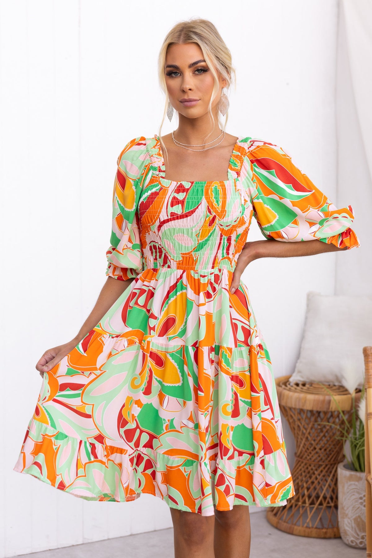 Tremmy Dress featuring a colorful floral print, elastic bodice, and puff sleeves in a flattering fit.