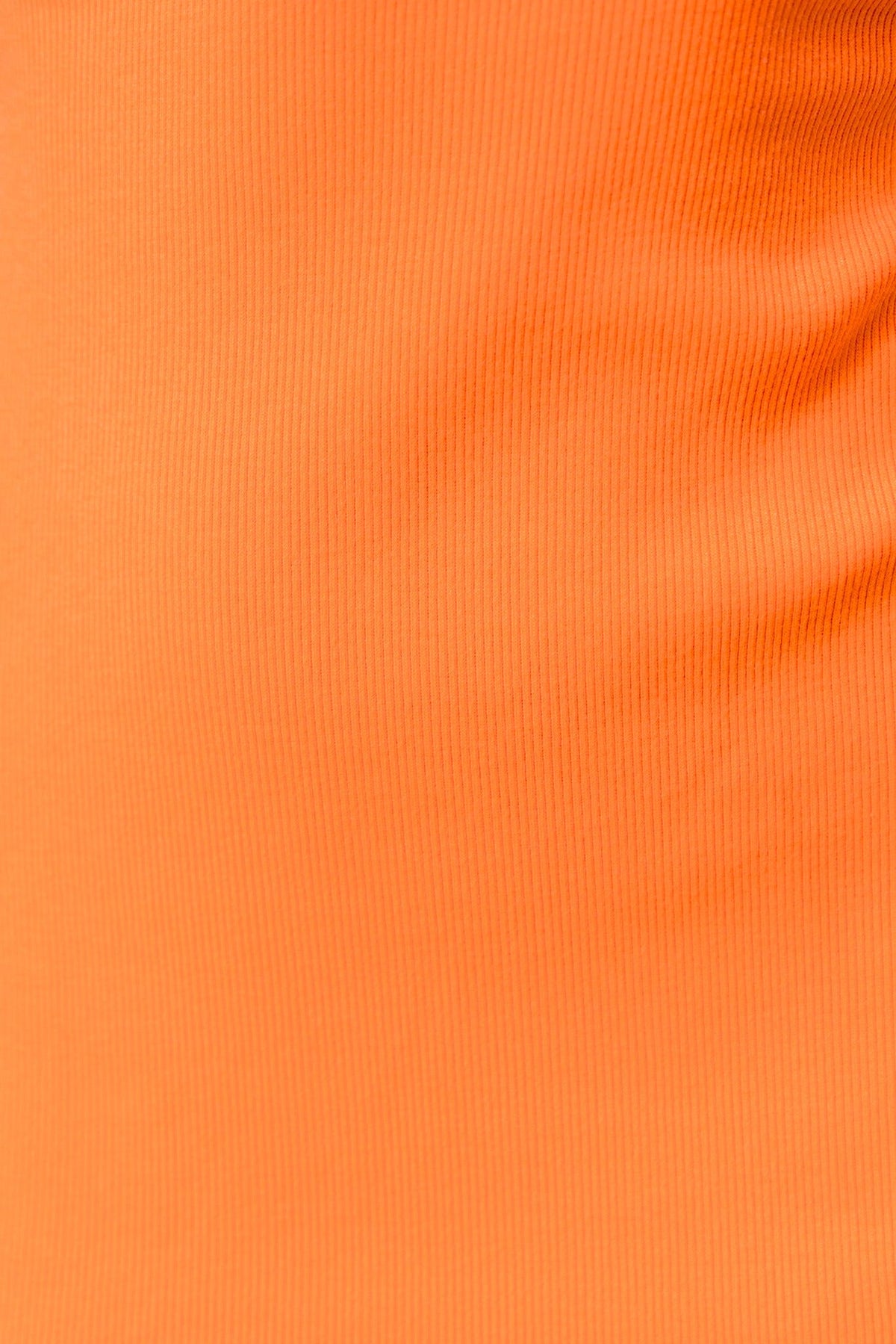 Close-up of ribbed orange fabric, showcasing texture and stretch features for fashion applications.