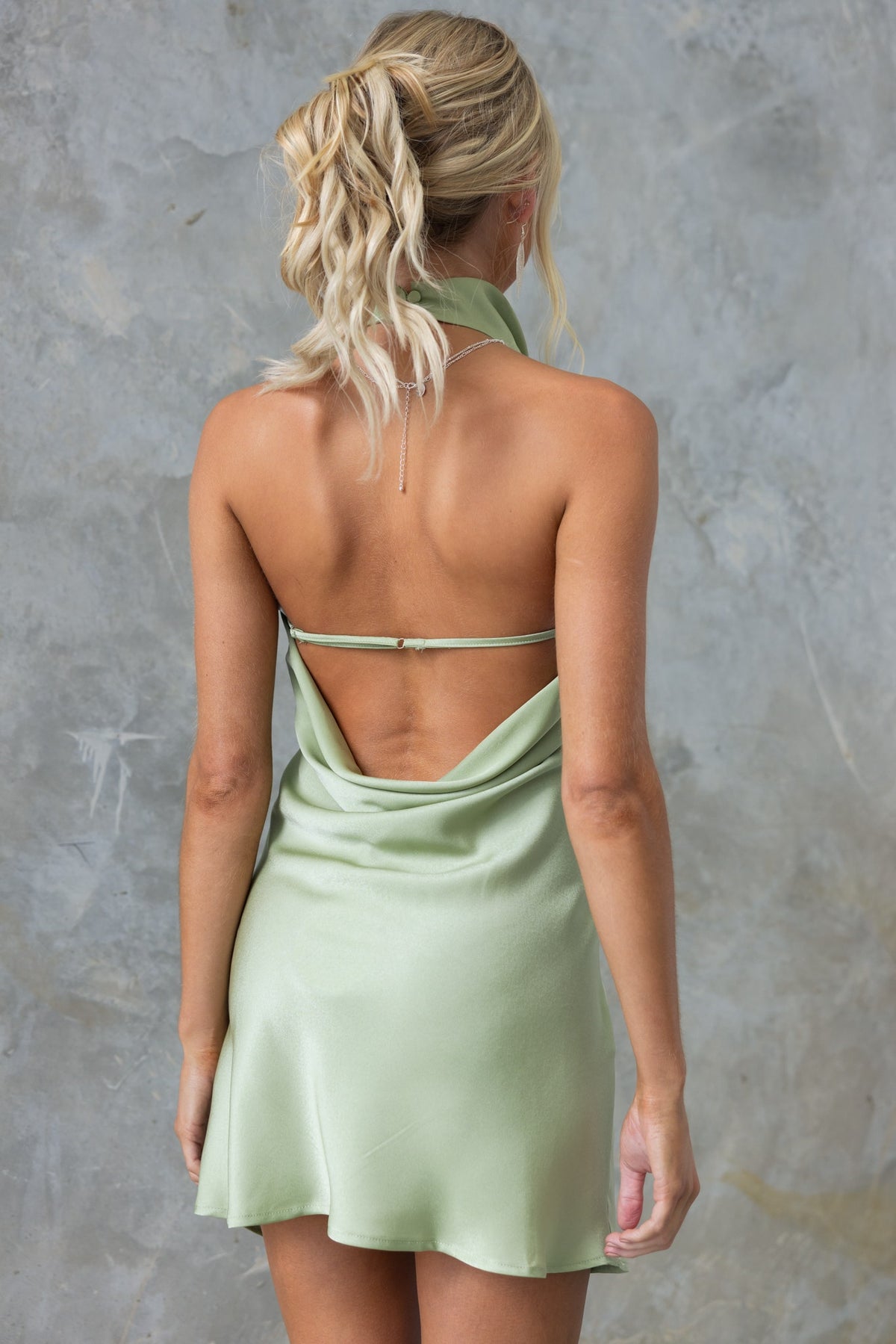 Back view of Ankana Dress showcasing adjustable straps and satin finish in a light green color.