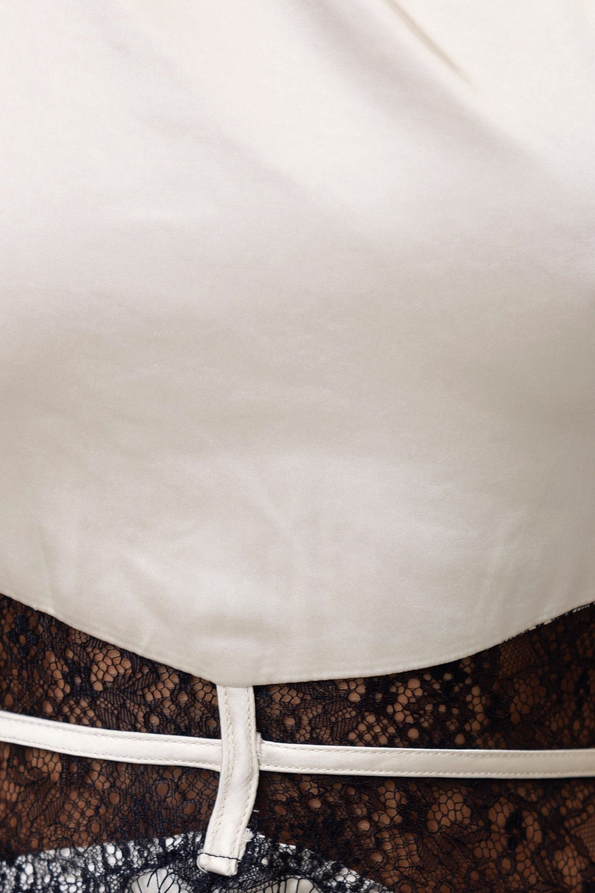 Close-up of Bombshell Maxi Dress showcasing satin fabric, lace detailing at waist, and adjustable straps.