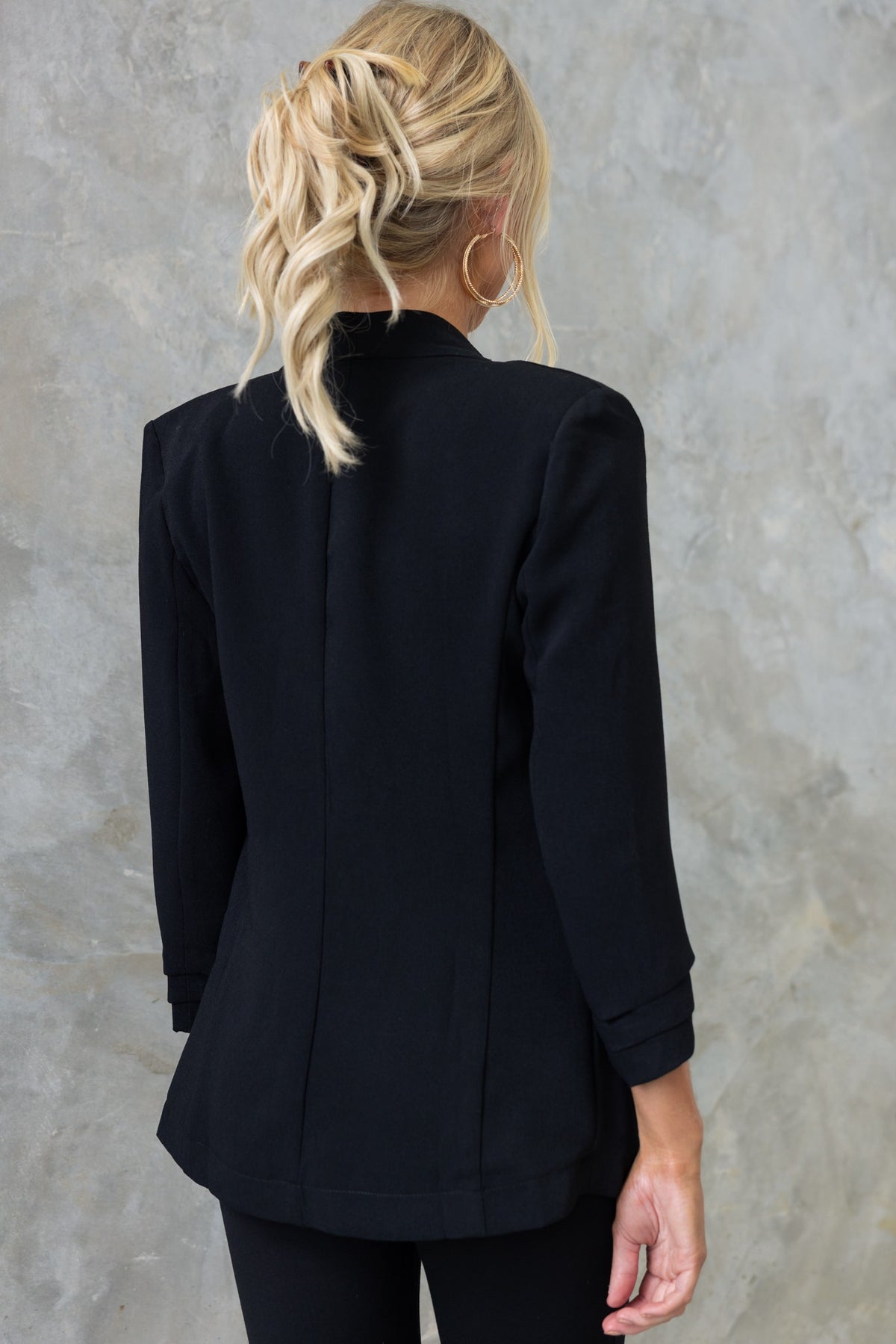 Back view of the Lupton Blazer in black, featuring pleated sleeves and a tailored design.