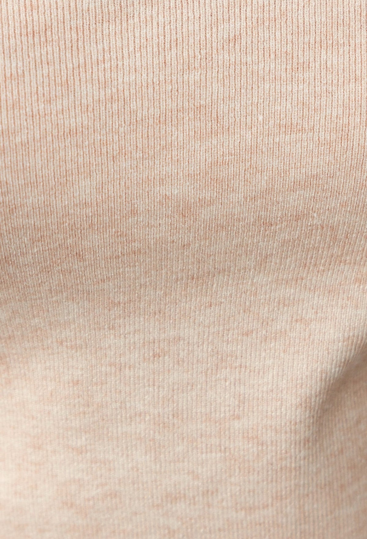 Close-up of ribbed knit fabric in soft beige color, showcasing texture and stretch for comfort.