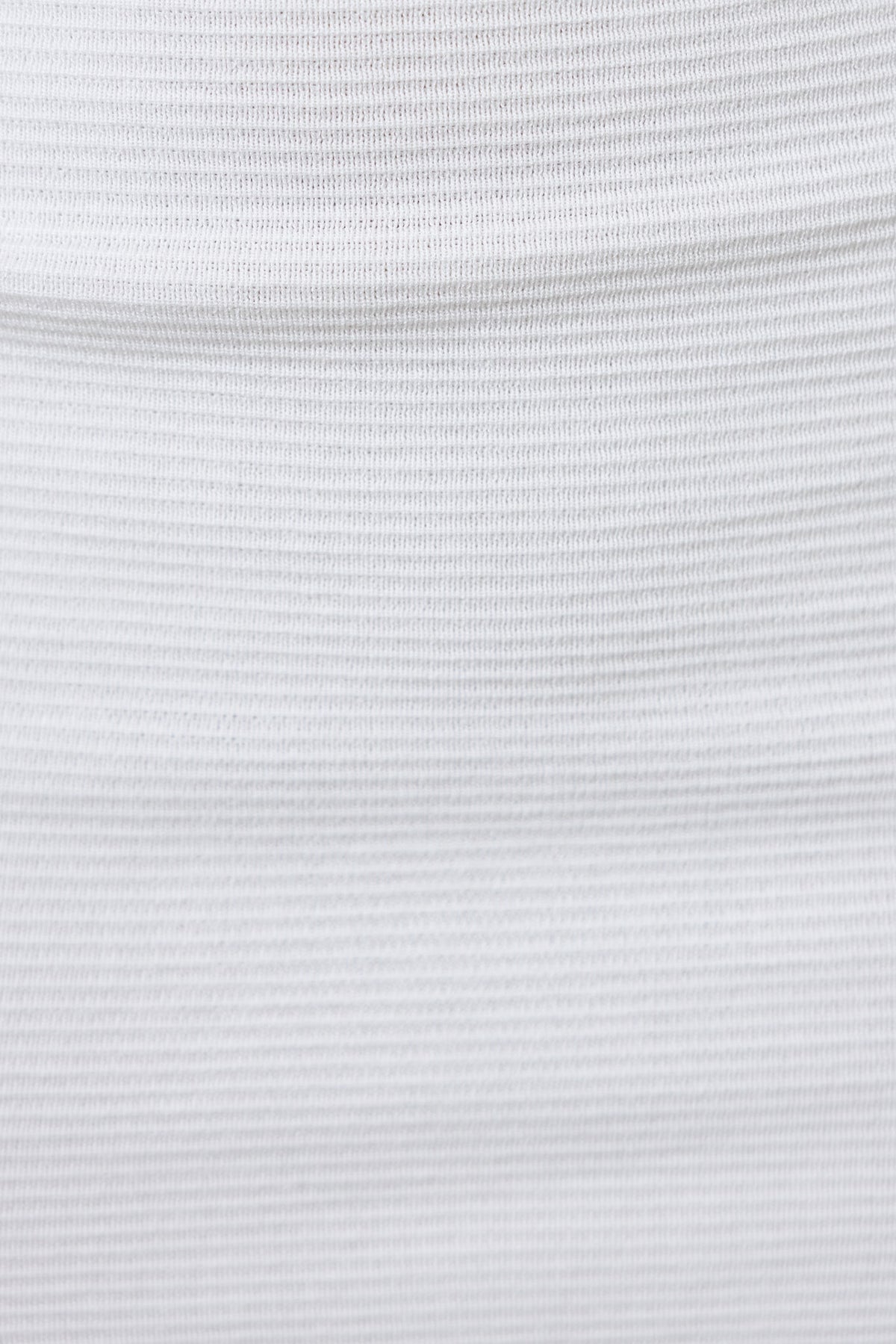 Close-up of textured white fabric, showcasing a smooth and stretchy material suitable for clothing.
