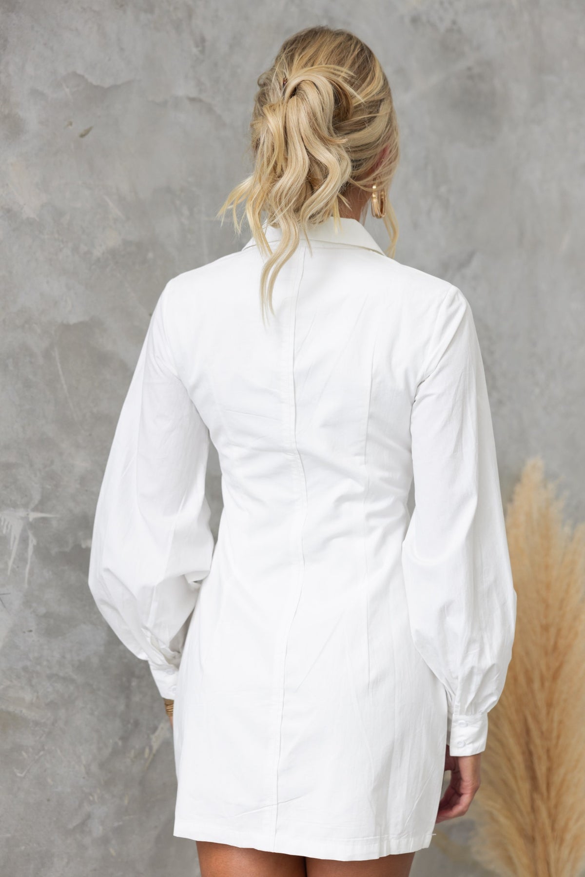 Back view of the Lanetta Dress featuring a V-neckline and puff sleeves, perfect for a stylish, casual look.