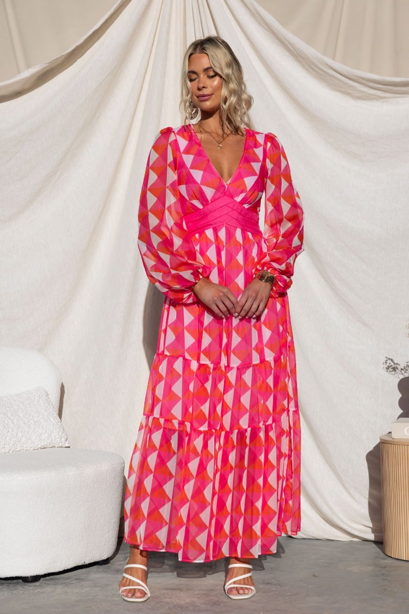 Cotta Maxi Dress featuring a vibrant multi-colour geometric pattern, V-neckline, and elastic cuffs on sleeves.