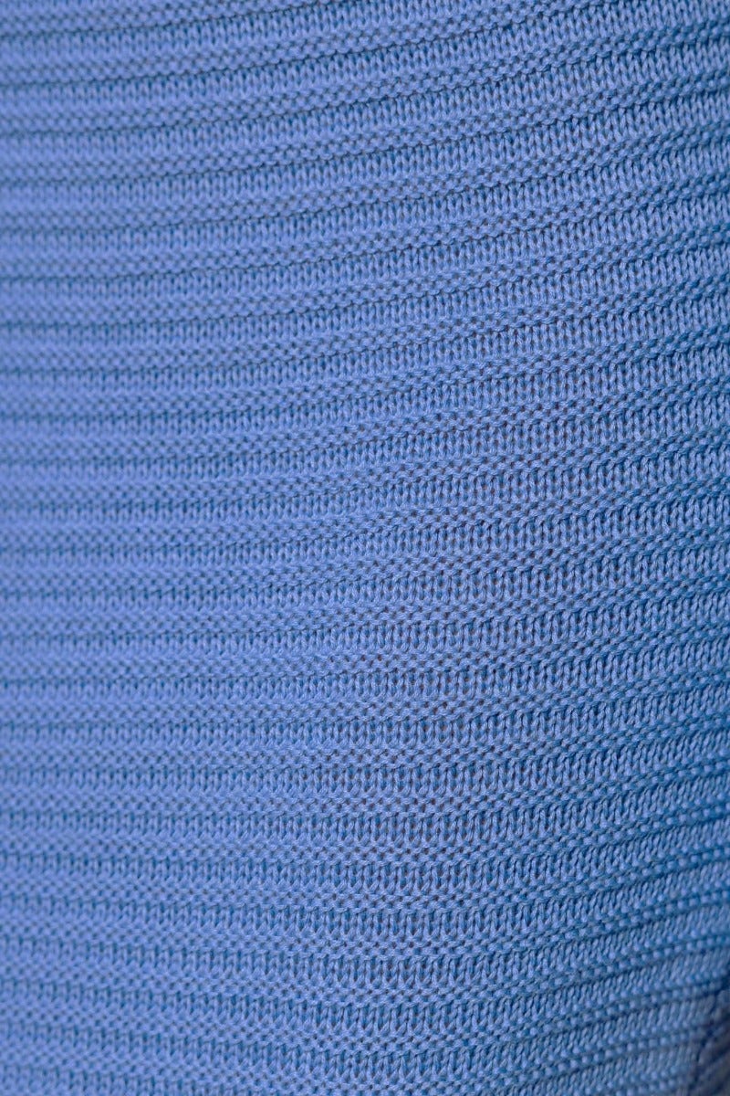 Close-up of Kholo Set crochet fabric in soft blue, showcasing its stretchy texture and high-quality material.