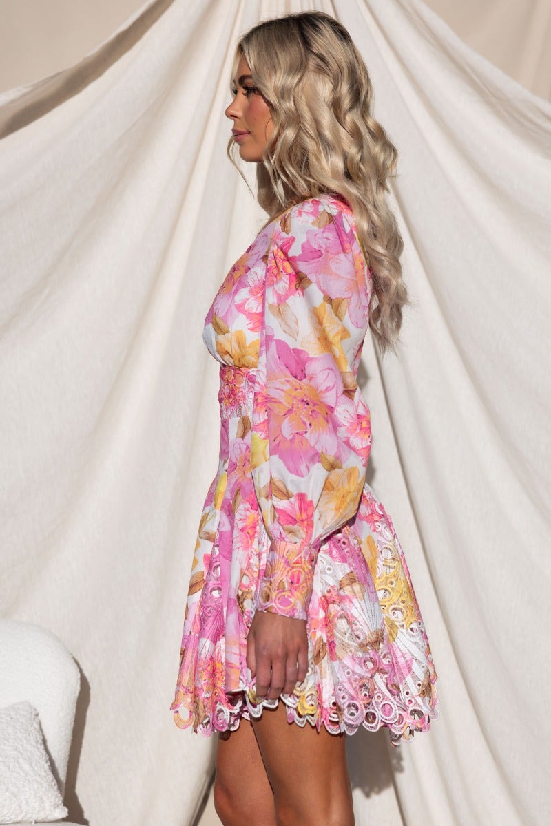 Chasing Dreams Dress features a pink floral design, lace detailing, and a stylish silhouette, perfect for summer occasions.