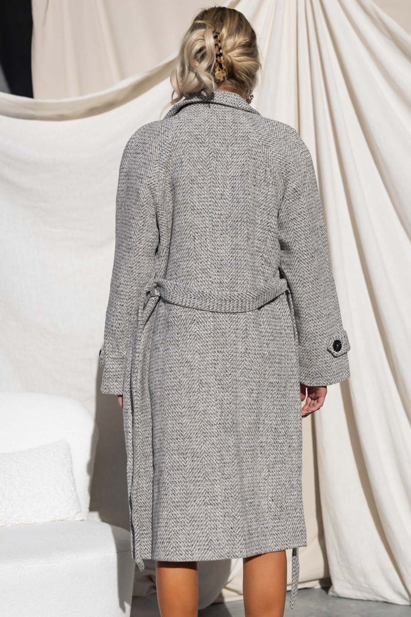 Back view of Atthow Coat in tweed look, featuring a longline fit, removable belt, and collar.