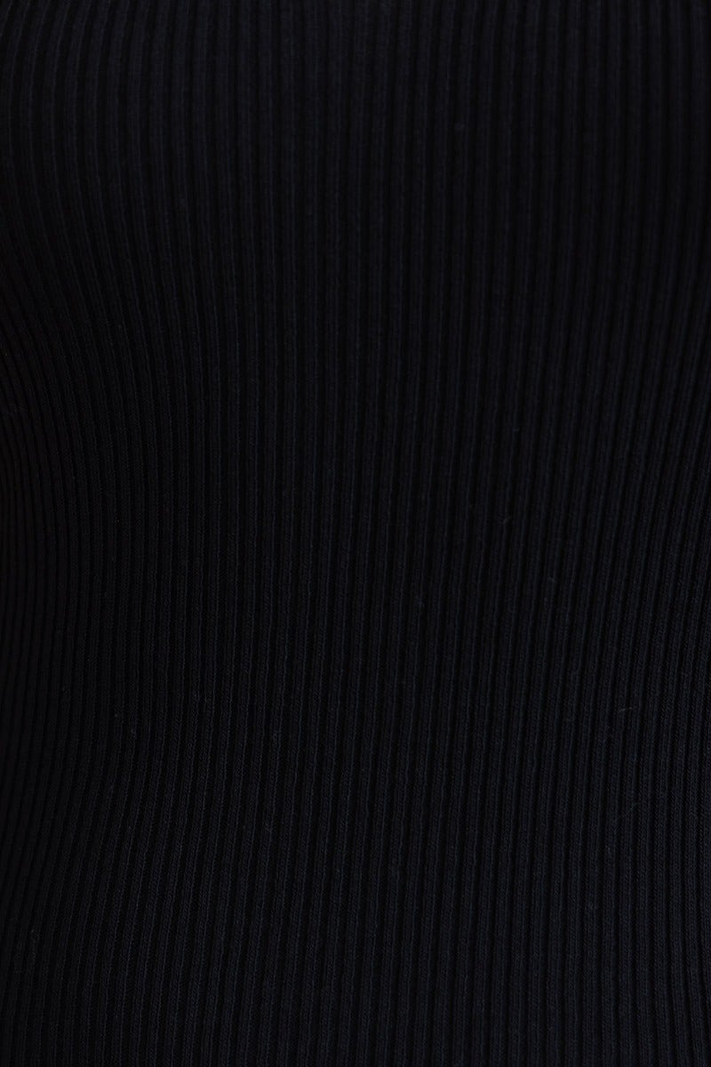 Close-up of black ribbed knit fabric of the Brinney Midi Dress, showcasing its stretchy material and high-quality finish.
