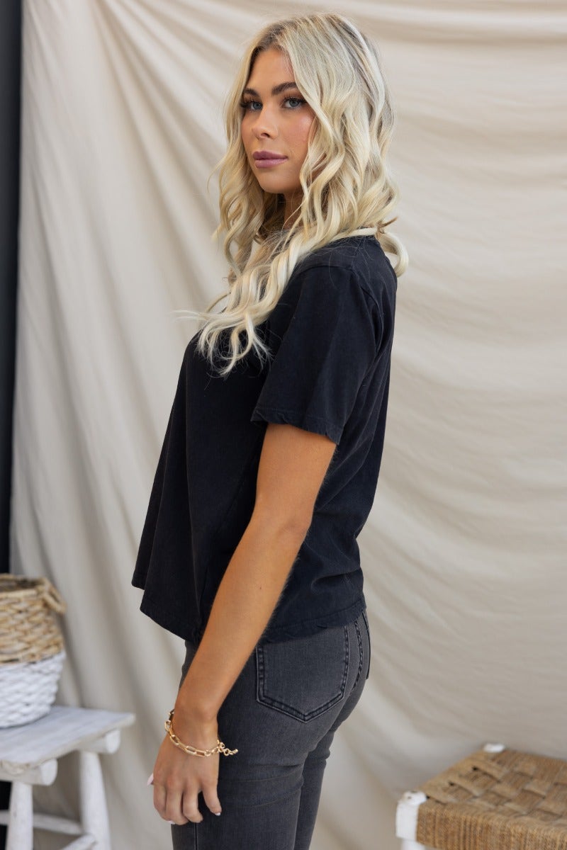 Model wearing a washed black Jerome Tee by Silent Theory, featuring a round neckline and slightly relaxed fit.