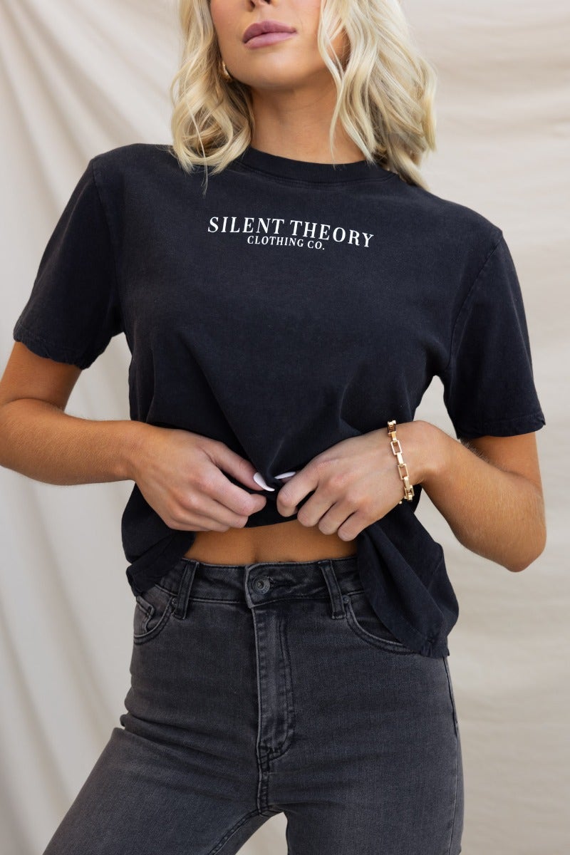 Model wearing a washed black 'Silent Theory Clothing Co' tee with a round neckline and relaxed fit.