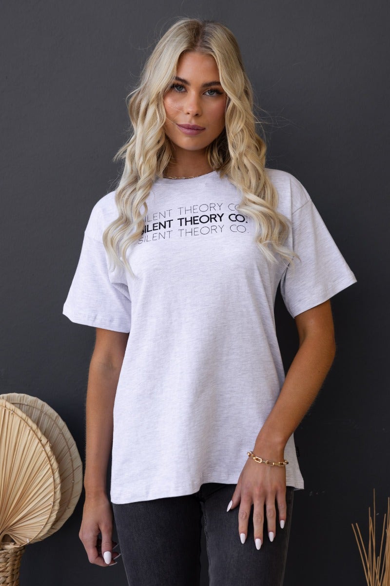 Model wearing the Ronan Tee by Silent Theory Co, showcasing a relaxed fit gray cotton t-shirt with round neckline.