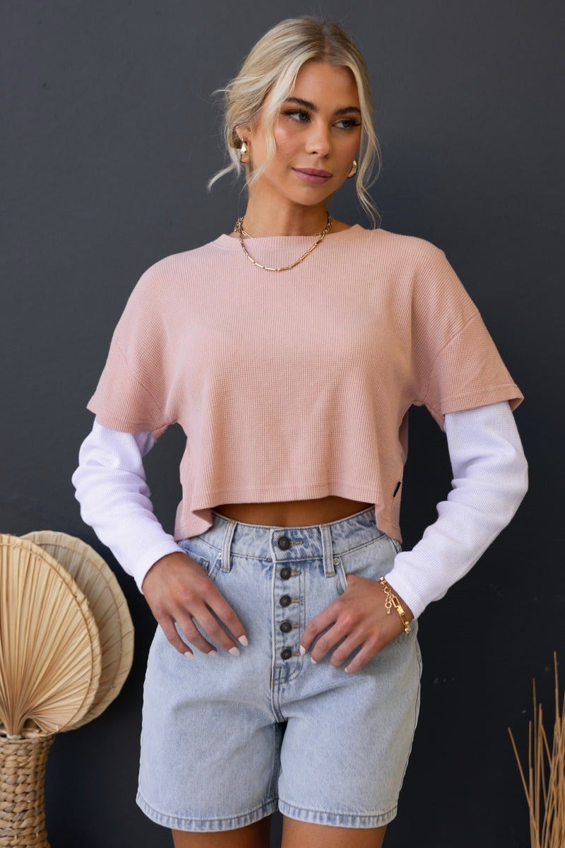 Tyrra Top in textured pink with round neckline, relaxed crop fit, featuring attached white sleeves, model wearing size 6/XS.