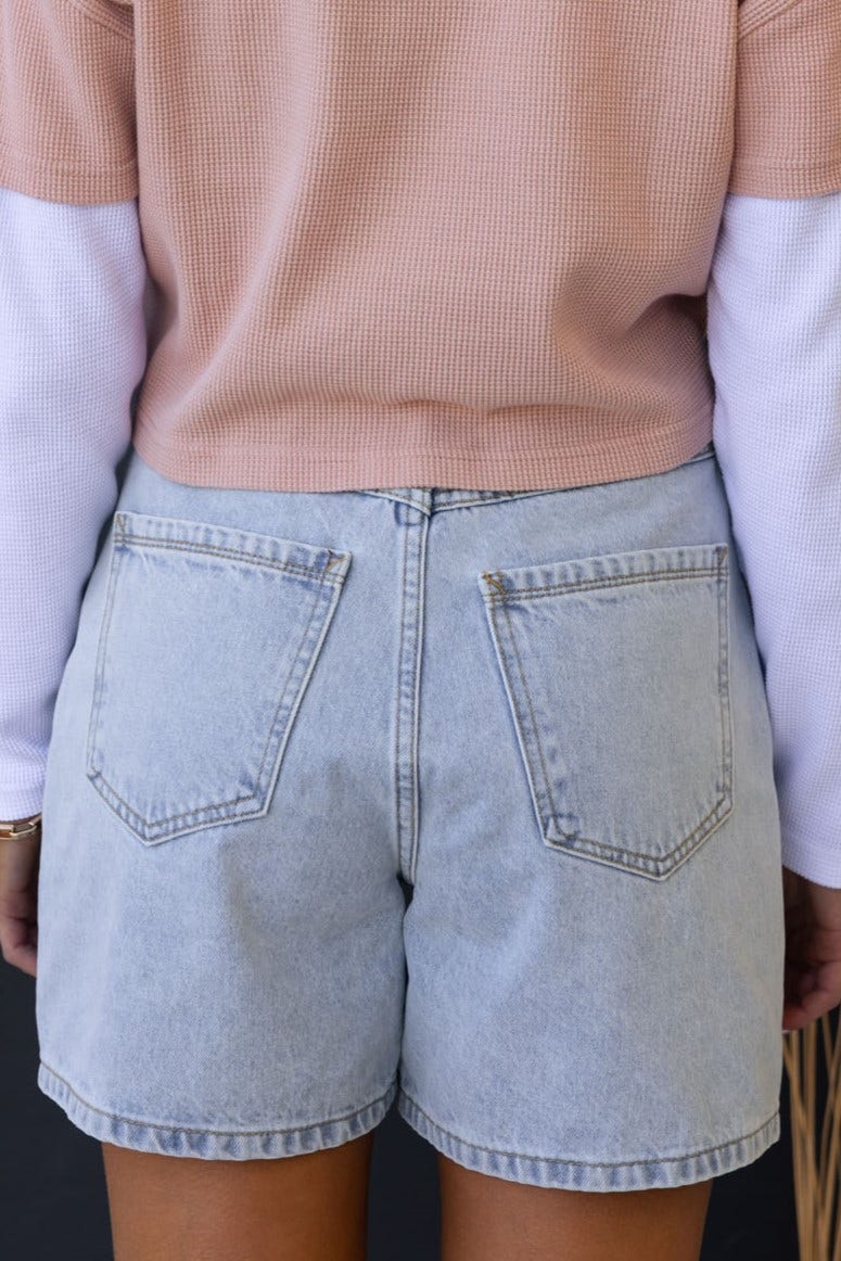 Rear view of Stazie denim shorts featuring non-stretch, mid-high waist fit and back pockets.