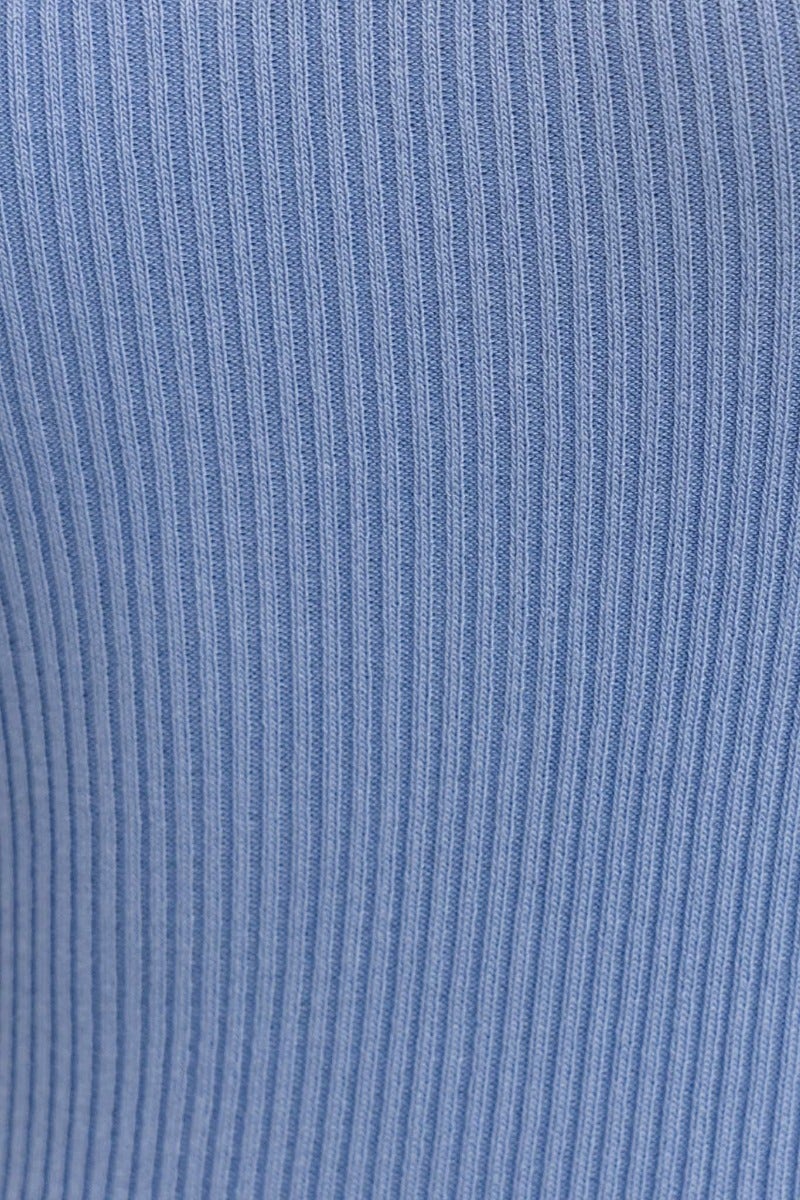 Close-up of ribbed knit material in soft blue, ideal for Brinney Midi Dress on a stylish outfit.