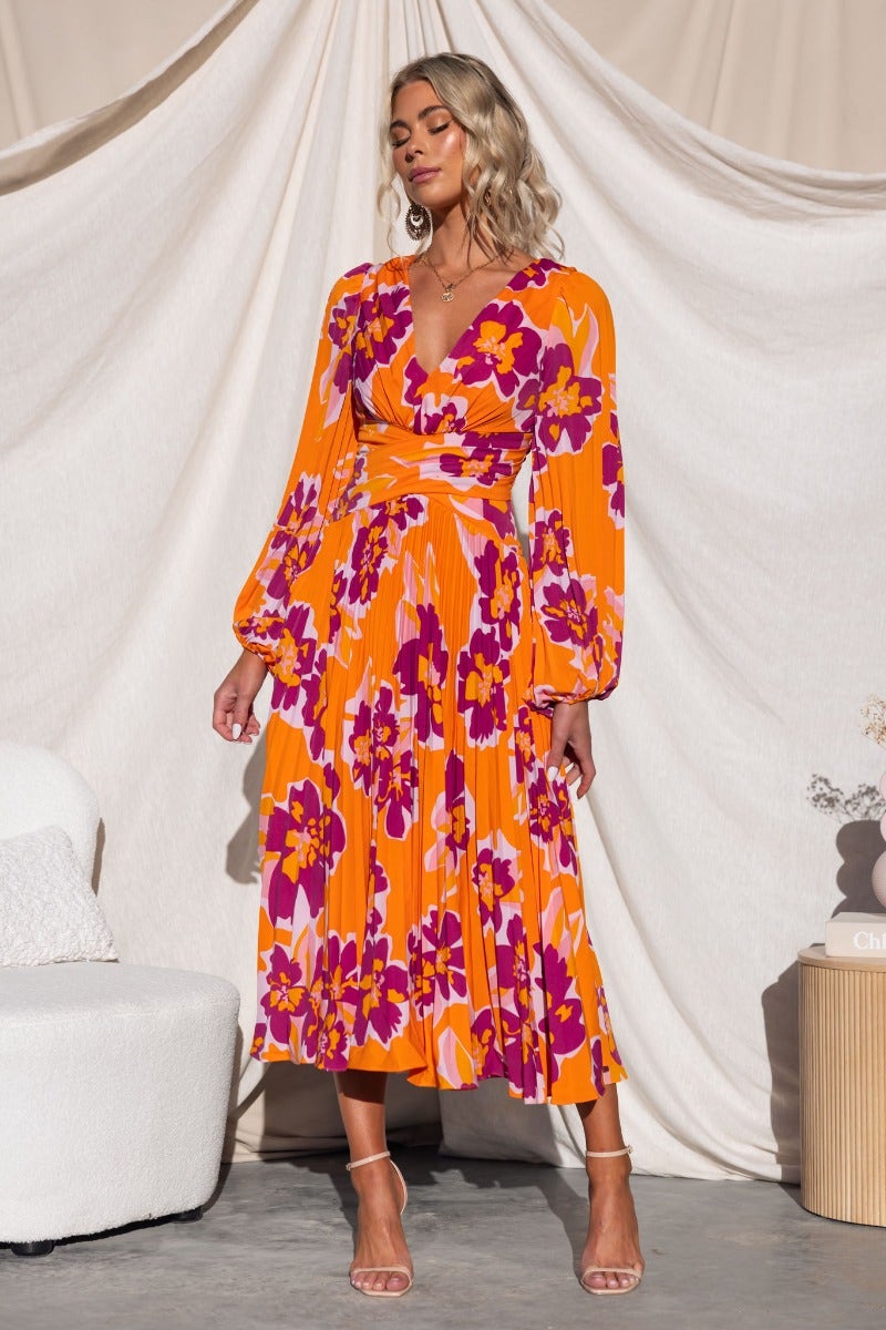 Normia Midi Dress featuring vibrant floral print, V-neckline, and cut-out back for a stylish look.