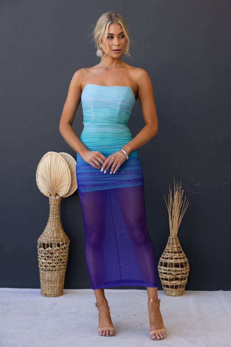 Strapless Velocity Maxi Dress with mesh overlay and ruched sides, featured on model against a dark background.