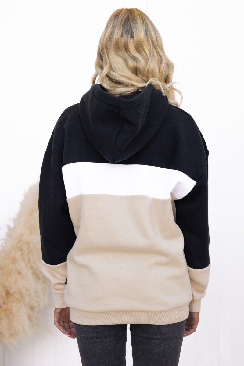 Back view of Nayle Jumper featuring black and beige color block design with an attached hood.