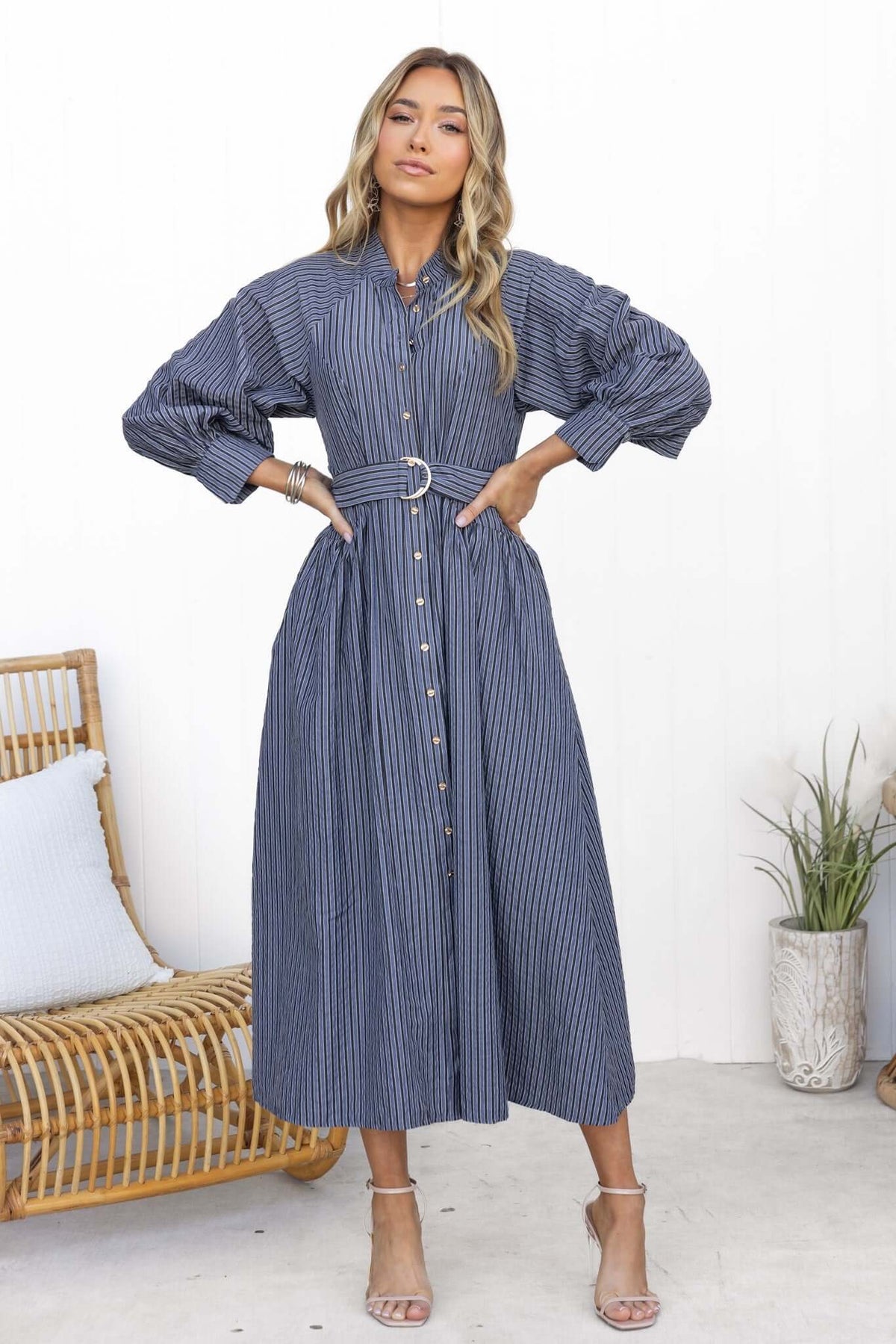 Model wearing a Greyer maxi dress with button-up front, elastic sleeves, and removable fabric belt.