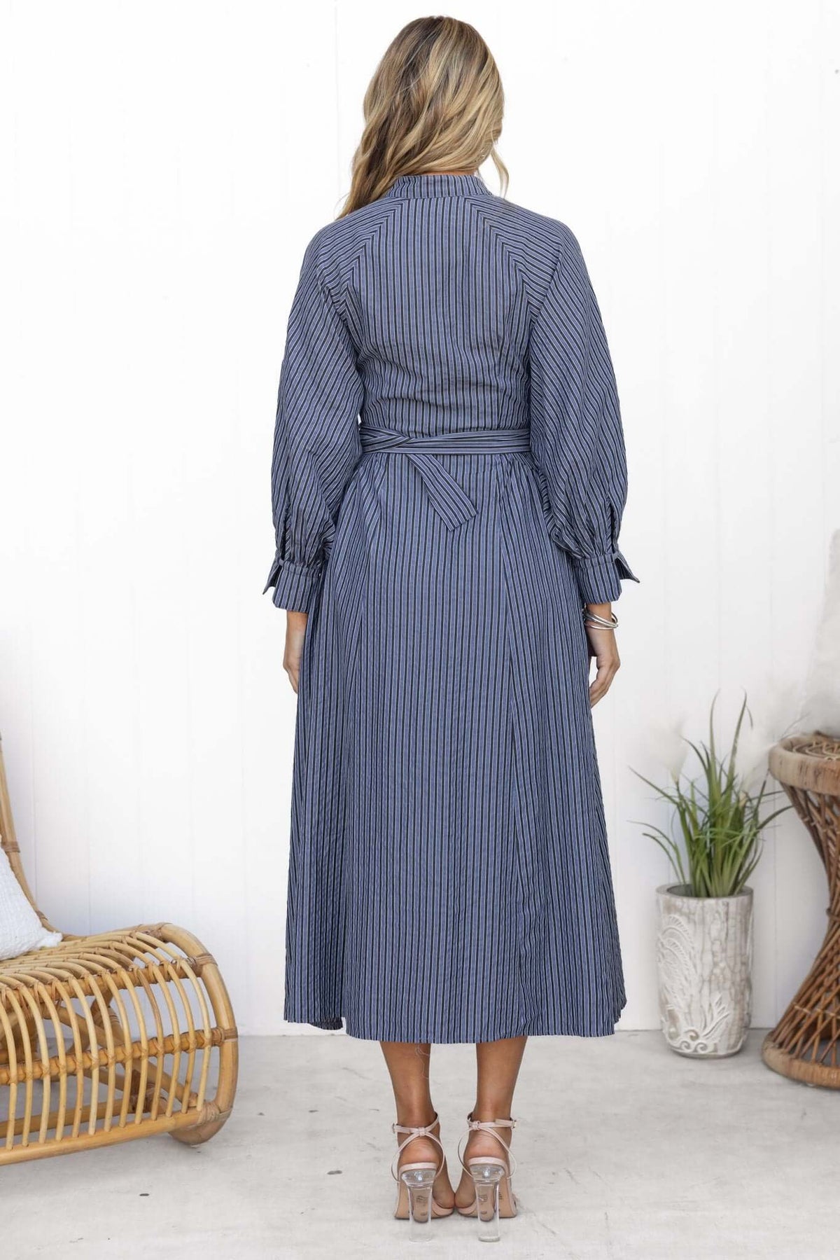 Back view of the Greyer Maxi Dress featuring a button-up front, elastic sleeves, and a removable belt.