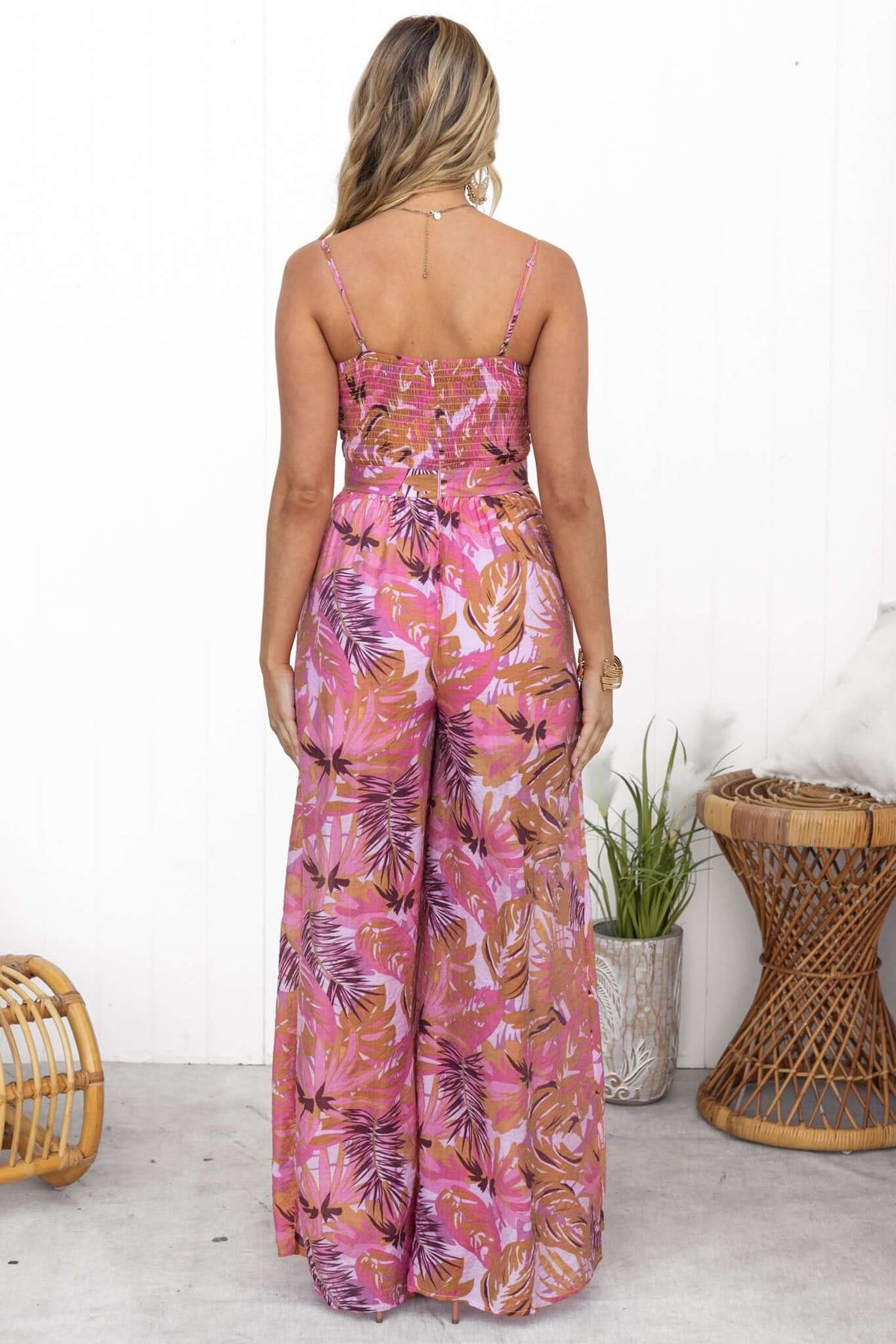 Back view of Sun Dazed Jumpsuit featuring multi-colour print, adjustable straps, and pockets.