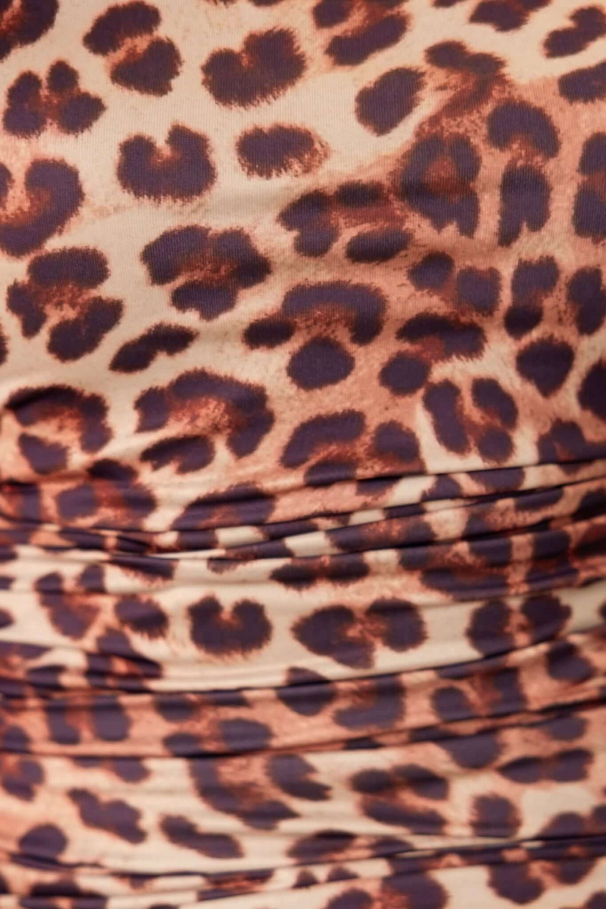 Close-up of leopard print fabric with ruching details, perfect for a stylish maxi dress.