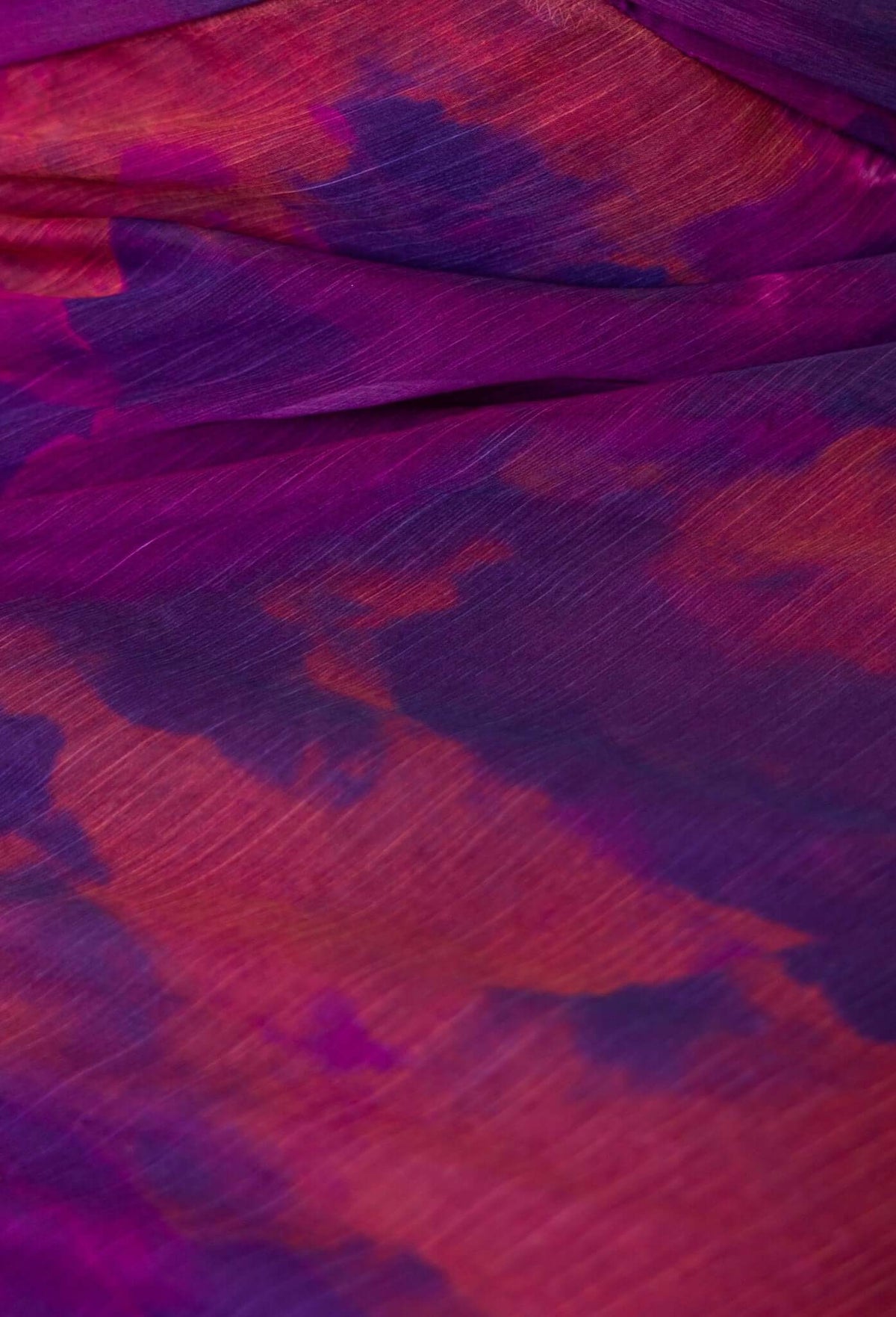 Close-up of colorful floral print fabric in shades of purple and orange, perfect for a Qoralee Midi Dress.