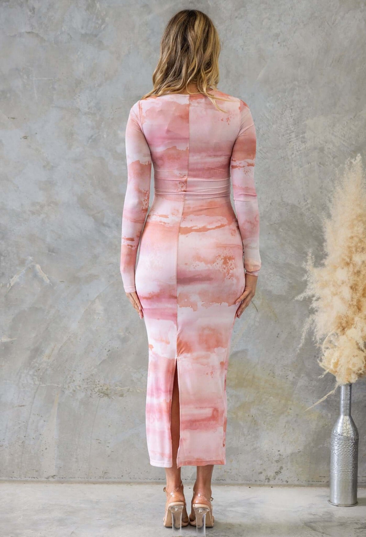 Back view of Neenah Maxi Dress featuring a pink marble print, long sleeves, and a back split detail.